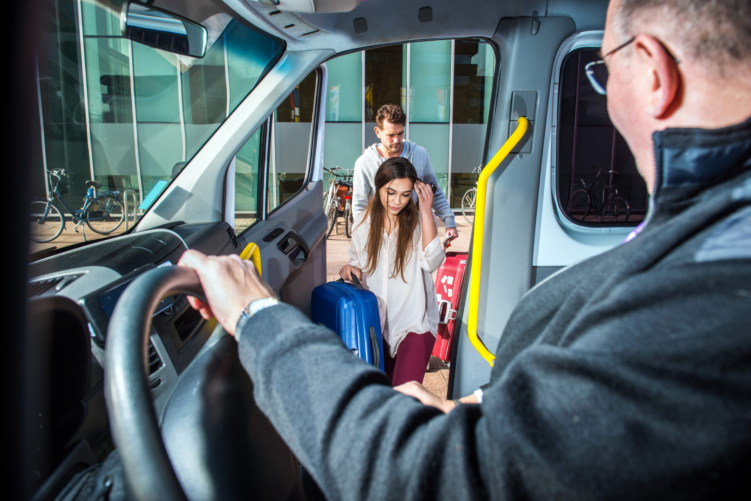 Minivan taxi picking up two passengers